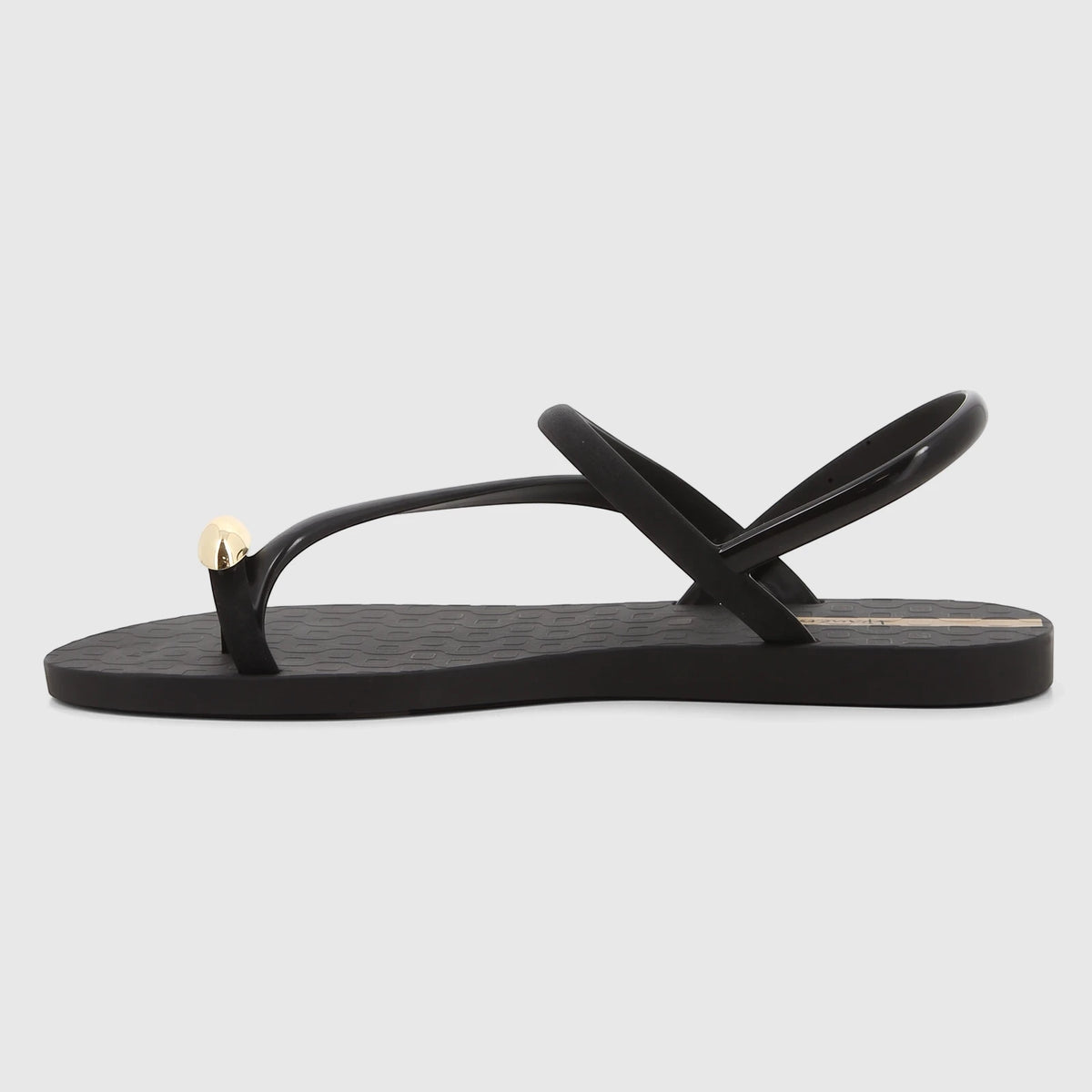 Ipanema Glam Ring Sandal in black with a gold toe ring detail, shown in a side profile view.