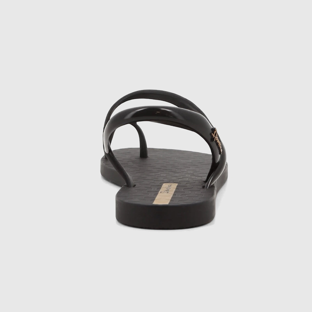 Black Ipanema Glam Ring sandal with glossy straps and a gold ring detail, shown from a back-side angle on a white background.