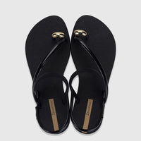 Ipanema Glam Ring Sandals in black with golden ring embellishments, featuring the brand logo, viewed from above.
