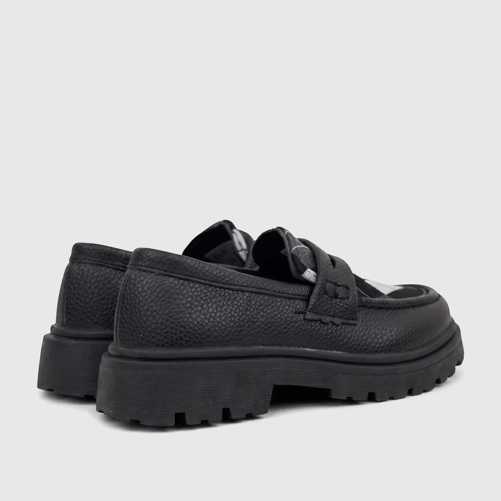 Klevas Boys black chunky sole loafers, featuring textured synthetic leather and a thick lug sole, seen from a rear-side view.