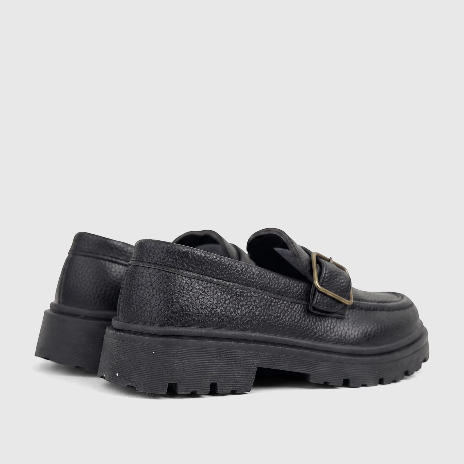 Pair of Klevas Boys black chunky sole monk strap loafers, featuring pebbled faux leather and a brass buckle.