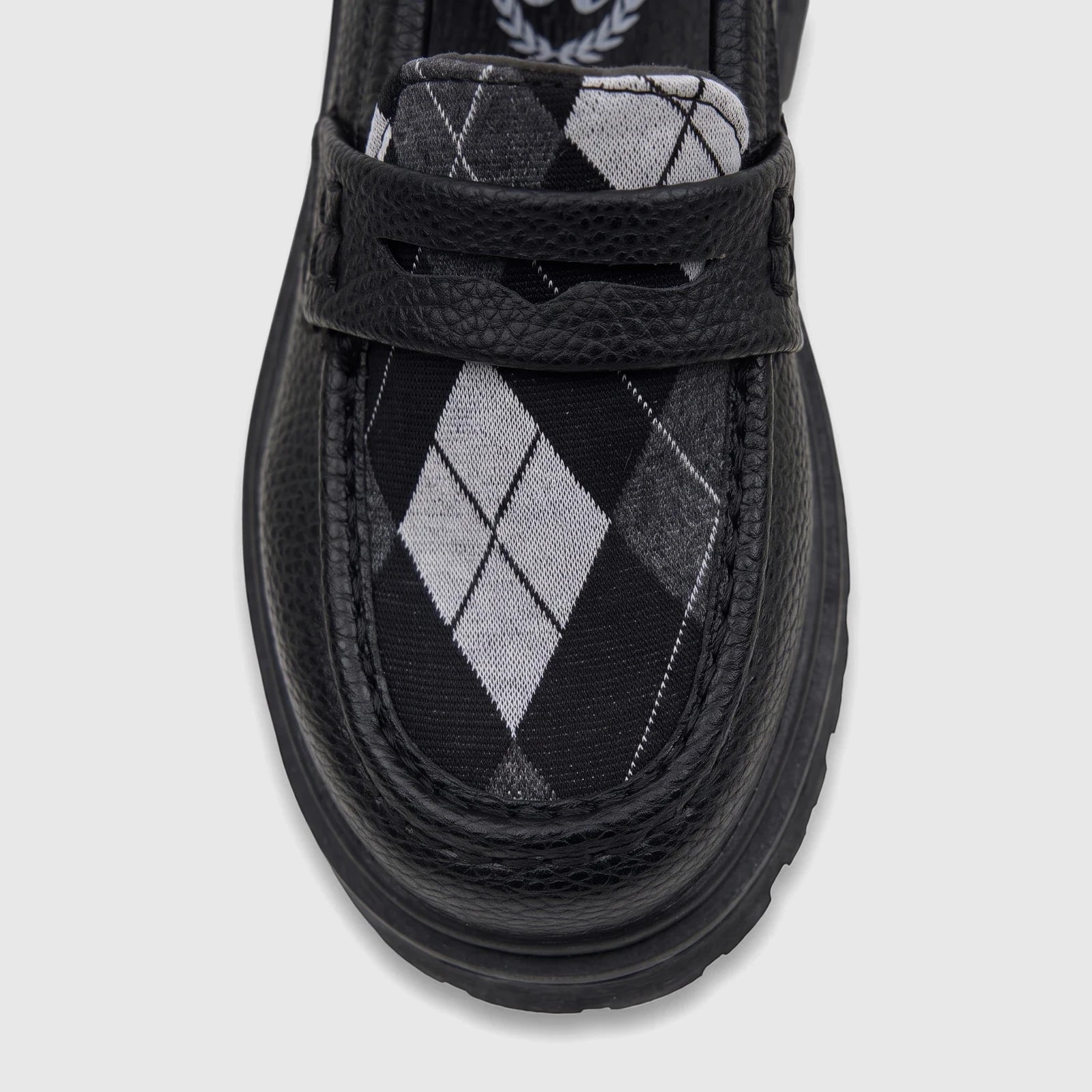Front view of Klevas Boys black chunky sole loafer, featuring a classic argyle pattern insert in shades of black, white, and