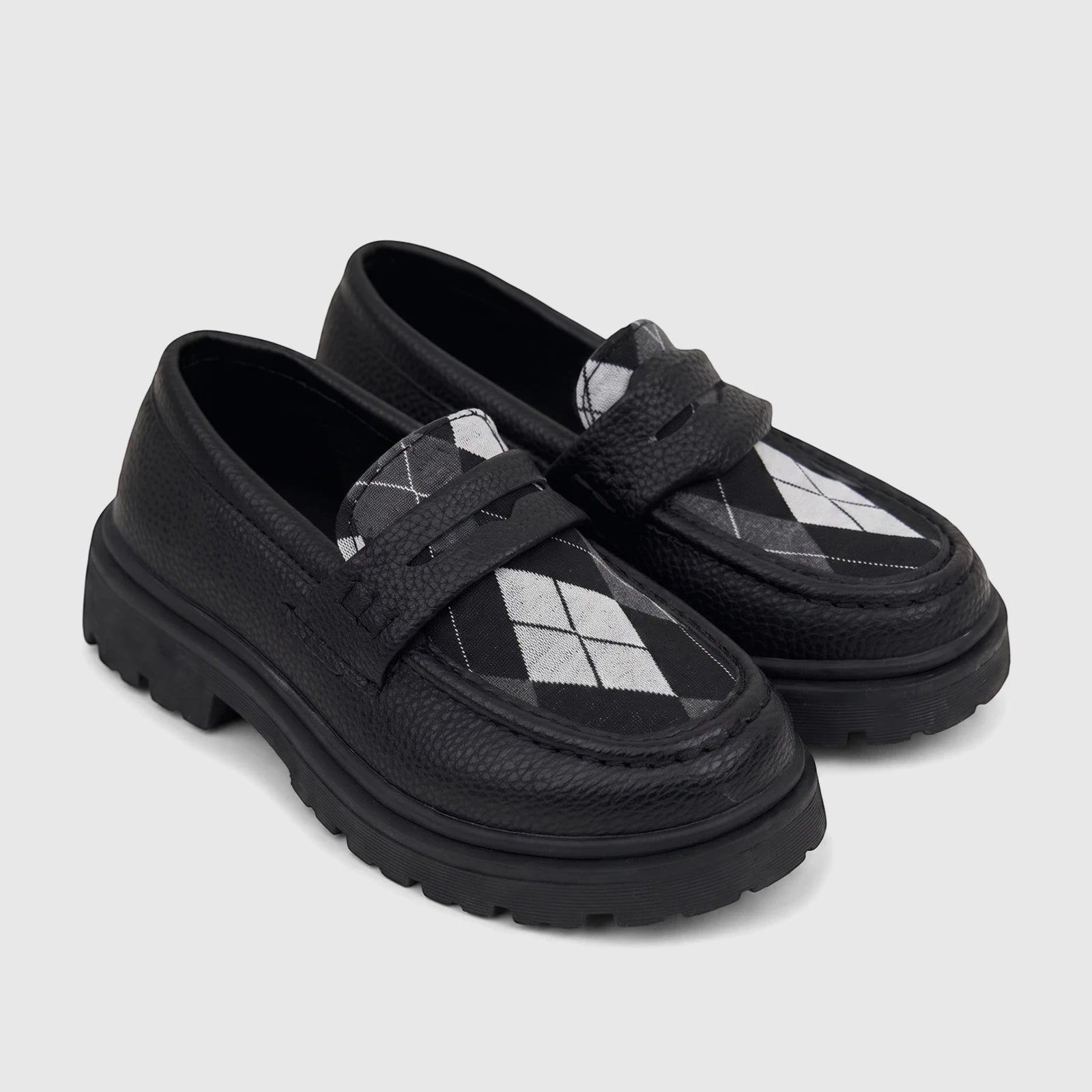 Pair of black Klevas Boys chunky sole loafers with white and gray argyle pattern detail on a white background.