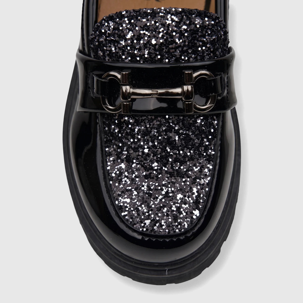 Klevas Boys chunky sole loafer in casino black patent leather with silver glitter details and horsebit hardware, close-up