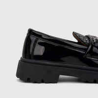 Close-up of a black patent leather Klevas Boys chunky sole loafer, showing the heel and side with a glitter accent and chain
