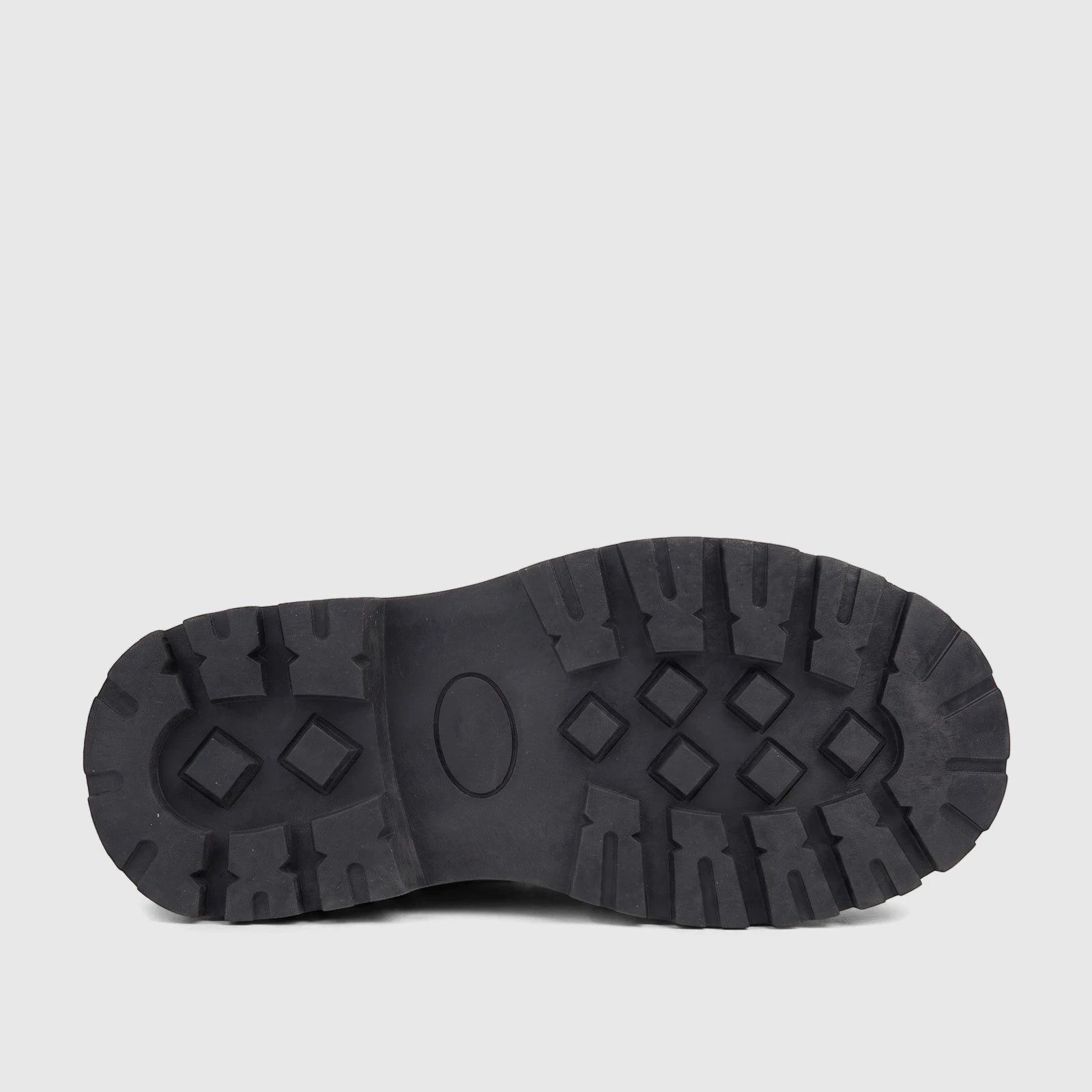Underside view of a black Klevas Boys chunky sole loafer, showcasing the distinctive diamond and rectangular tread pattern.