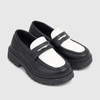Pair of Klevas Boys Chunky Sole Loafers in black and white, featuring a lug sole, presented at an angle.