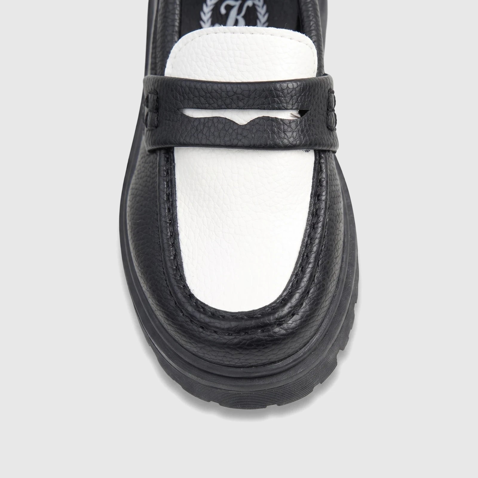 Front view of a Klevas Boys chunky sole loafer featuring a two-tone black and white textured faux leather design with a