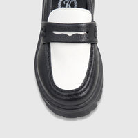 Front view of a Klevas Boys chunky sole loafer featuring a two-tone black and white textured faux leather design with a