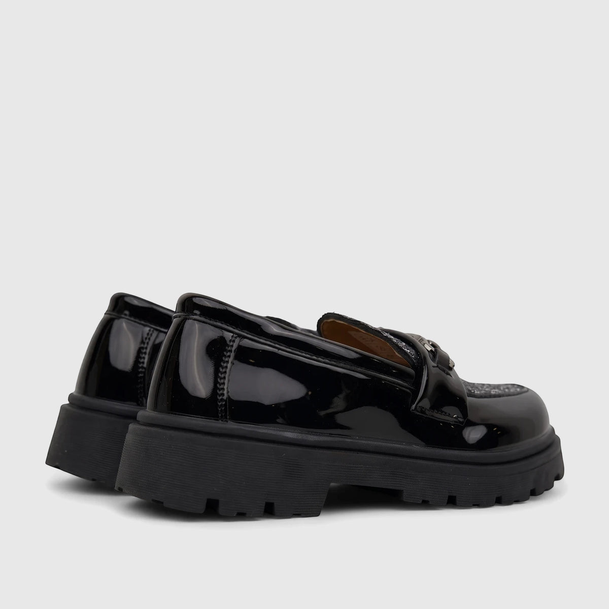 Pair of Klevas Boys chunky sole loafers in casino black patent leather, viewed from a side angle.