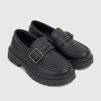 Two black boys' chunky sole loafers with monk straps and brass-toned buckles, made of textured faux leather.
