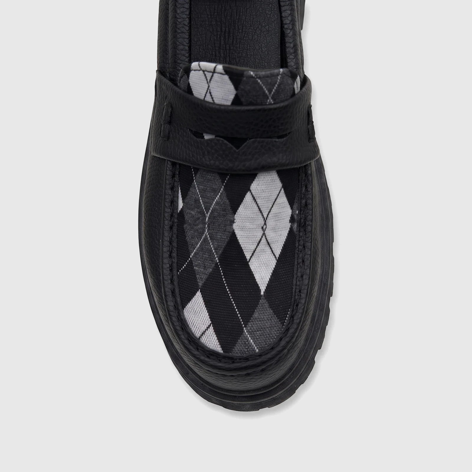 Black Klevas Boys Youth chunky sole loafer with a black, white, and grey argyle pattern on the vamp, photographed from a