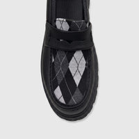 Black Klevas Boys Youth chunky sole loafer with a black, white, and grey argyle pattern on the vamp, photographed from a