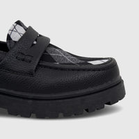 Close-up of a black Klevas Boys Youth chunky sole loafer with a black and white argyle pattern on the vamp, viewed from the