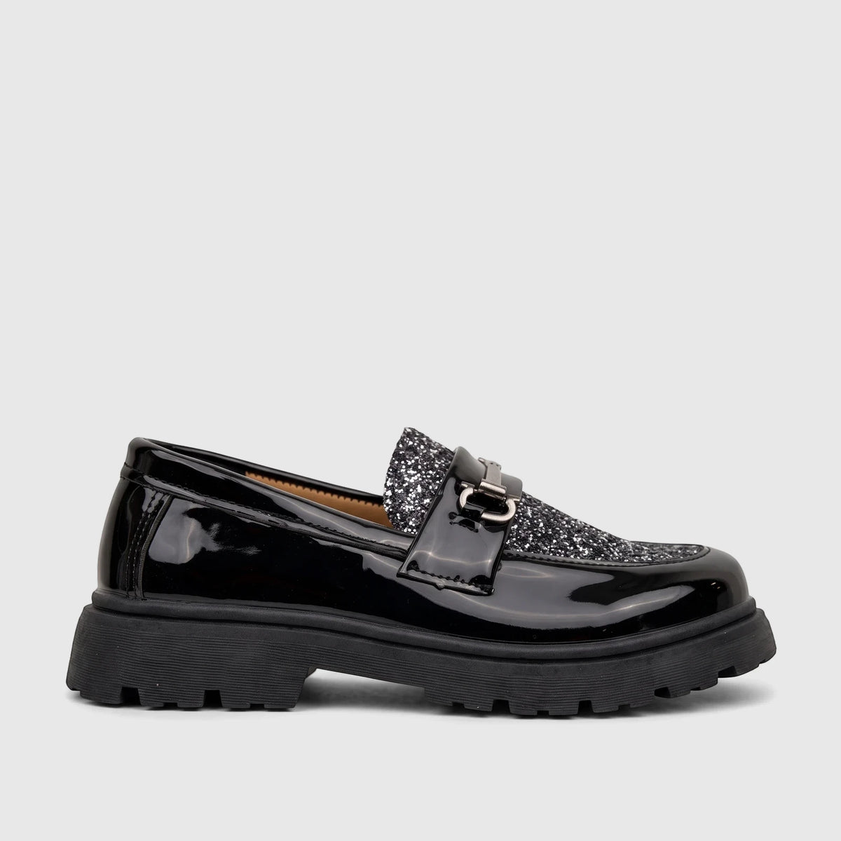 A Klevas Boys Youth chunky sole loafer in shiny black patent leather with a glitter panel and silver buckle.