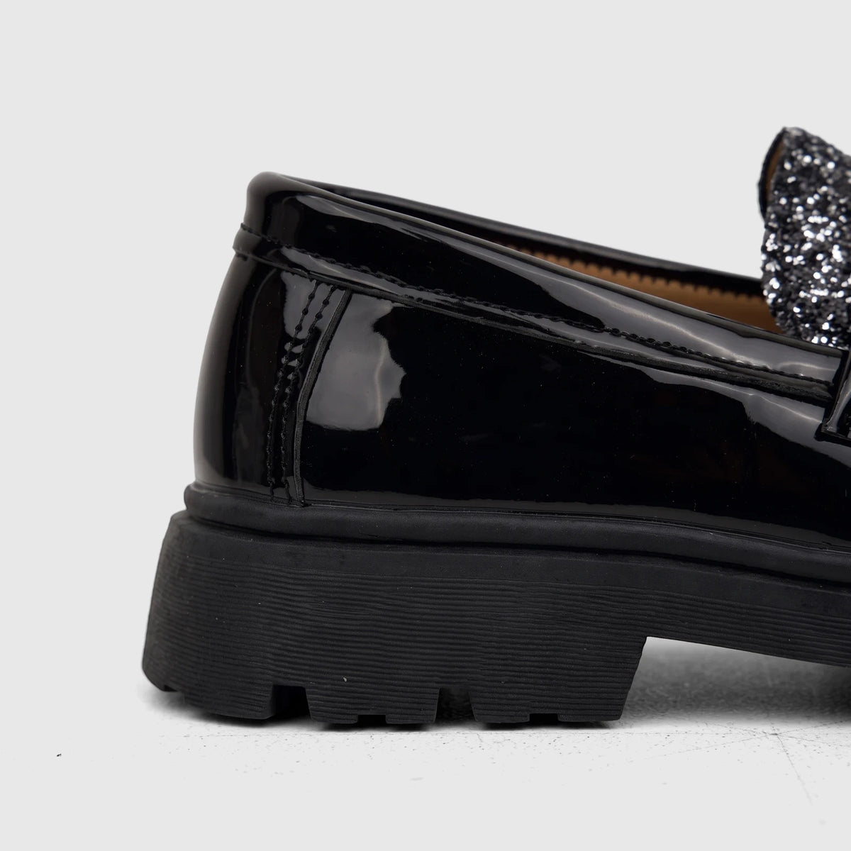 Klevas Boys Youth chunky sole loafer in casino black patent leather, featuring glitter detail and a silver buckle, side view.