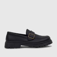 Black Klevas Boys Youth chunky sole loafer with a gold monk strap buckle, photographed from a side view.