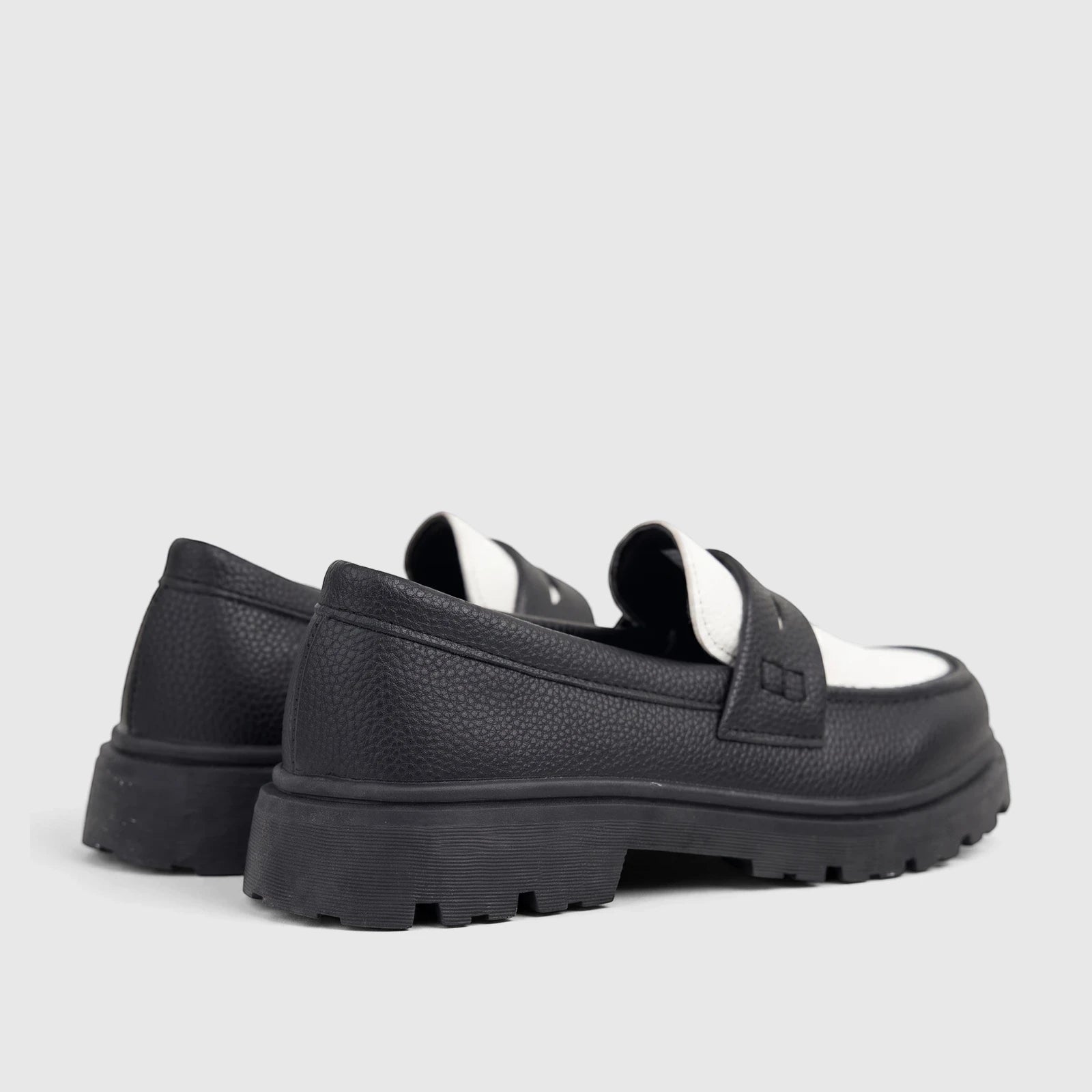 Klevas Boys Youth black and white chunky sole loafers, featuring textured uppers and thick lugged soles, viewed from the
