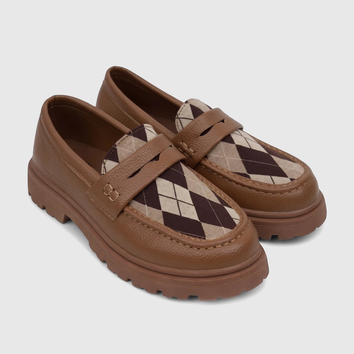 A pair of Klevas Boys Youth chunky sole loafers in bowling tan, featuring textured brown leather and an argyle patterned