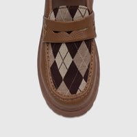 Close-up of a Klevas Boys Youth chunky sole loafer in bowling tan with a distinctive argyle pattern.