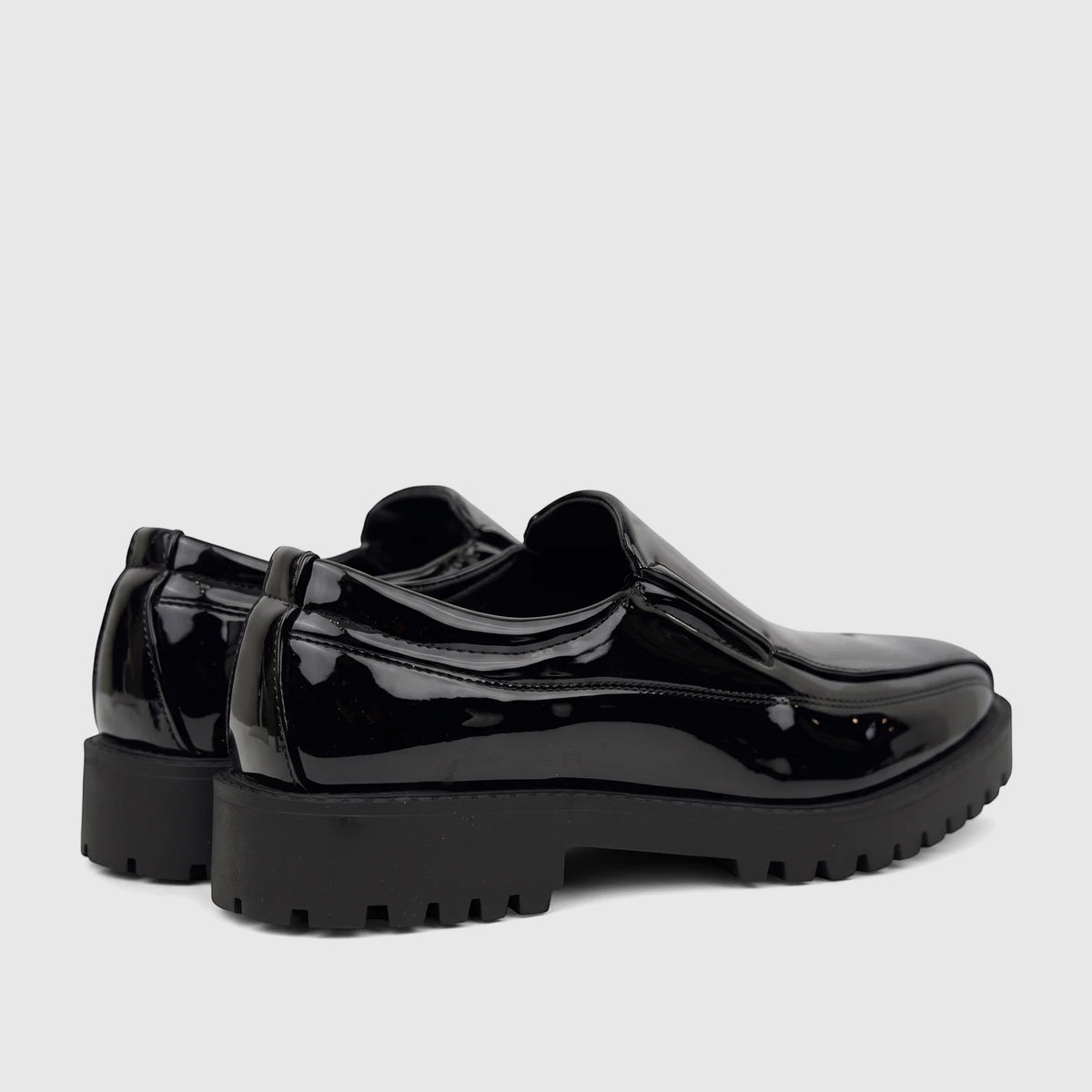A pair of Klevas Men's black patent leather chunky sole loafers, featuring a glossy finish and rugged lug soles.