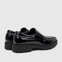 A pair of Klevas Men's black patent leather chunky sole loafers, featuring a glossy finish and rugged lug soles.