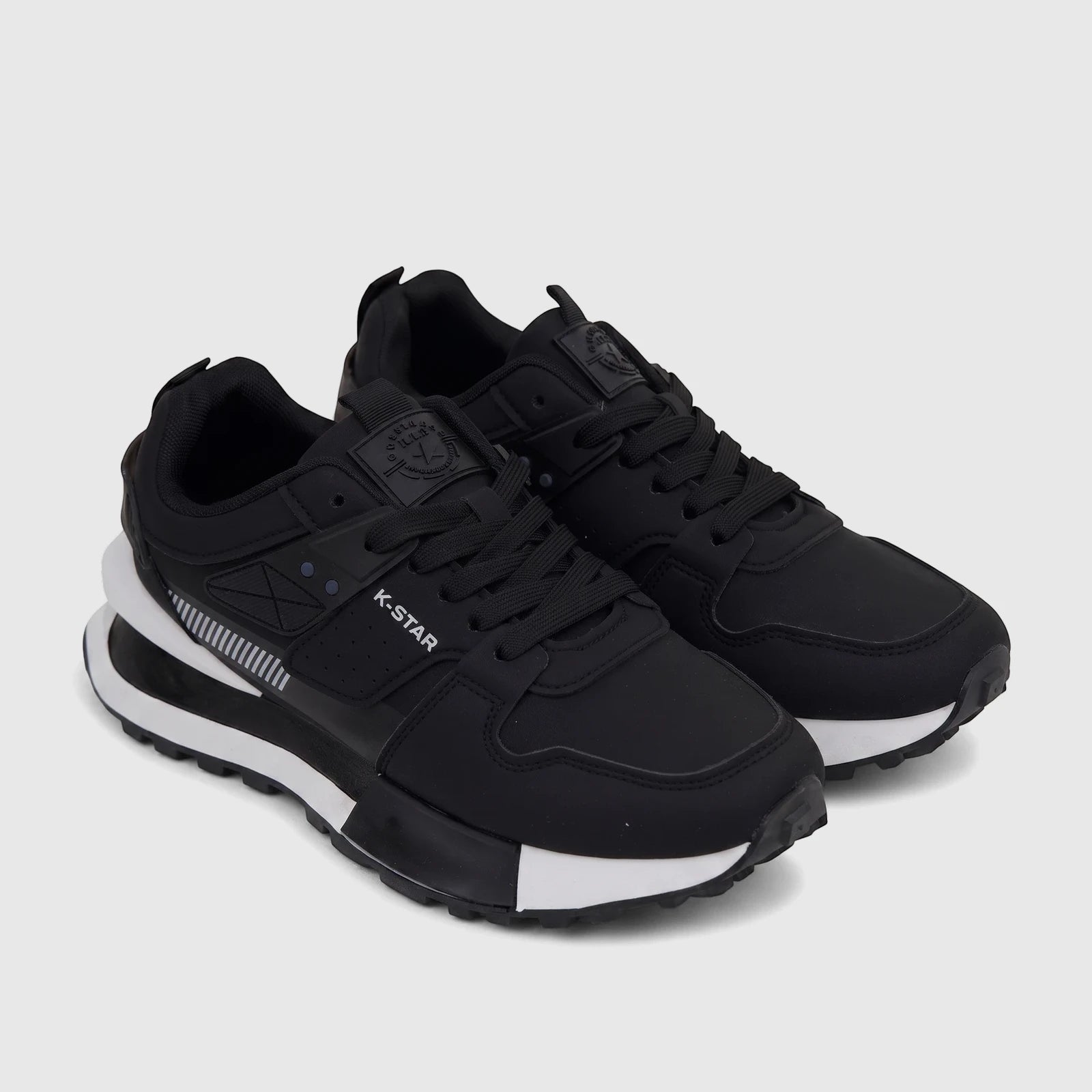 Pair of Klevas men's casual black sneakers with white soles and black laces, shown from a slightly elevated side view.