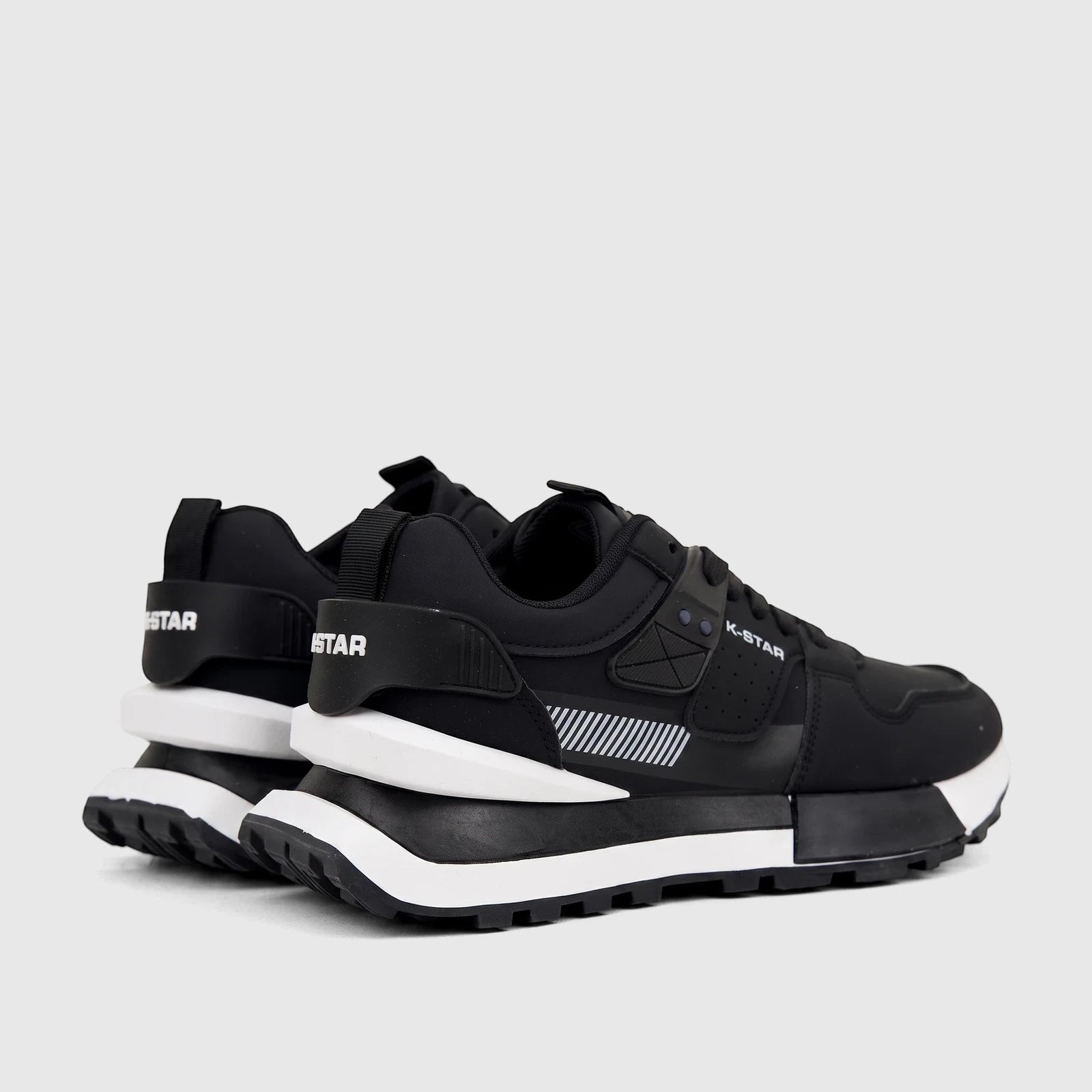 A pair of Klevas Men's Casual Sneaker Ice K7622M black sneakers with white soles, presented from a detailed side view.