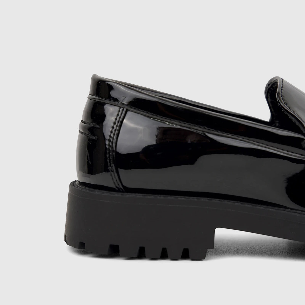 Close-up side view of a Klevas Men's Chunky Sole Loafer Bass K8196M in black patent leather with a prominent lug sole.