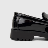 Close-up side view of a Klevas Men's Chunky Sole Loafer Bass K8196M in black patent leather with a prominent lug sole.