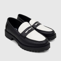 A pair of Klevas Men's Chunky Sole Loafers in black and white, featuring a pebbled texture and a wavy penny strap design.