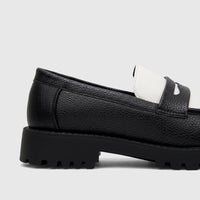 Close-up side view of a Klevas Men's Chunky Sole Loafer in black and white with a pebbled texture.