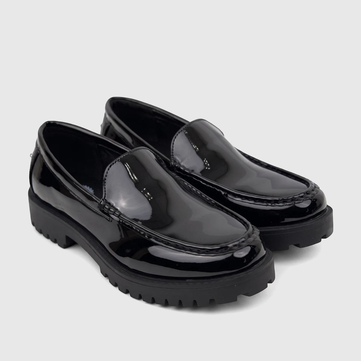 Pair of Klevas Men's chunky sole loafers in black patent leather, showcasing the shiny finish and lugged platform soles.