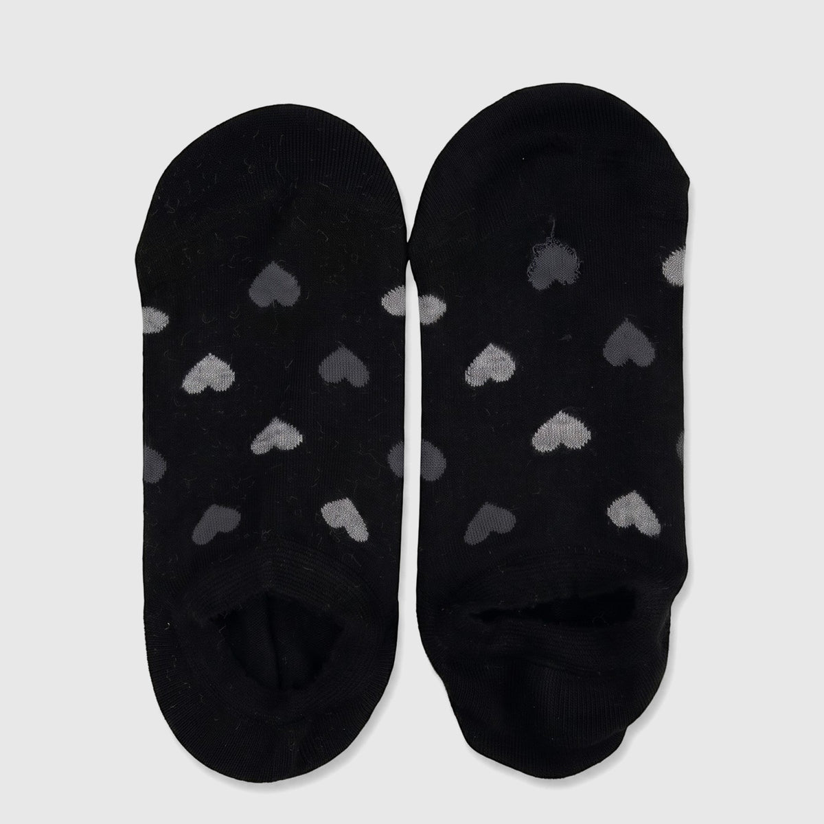 Pair of ladies black bamboo invisible socks with a grey heart pattern, displayed flat on a surface.