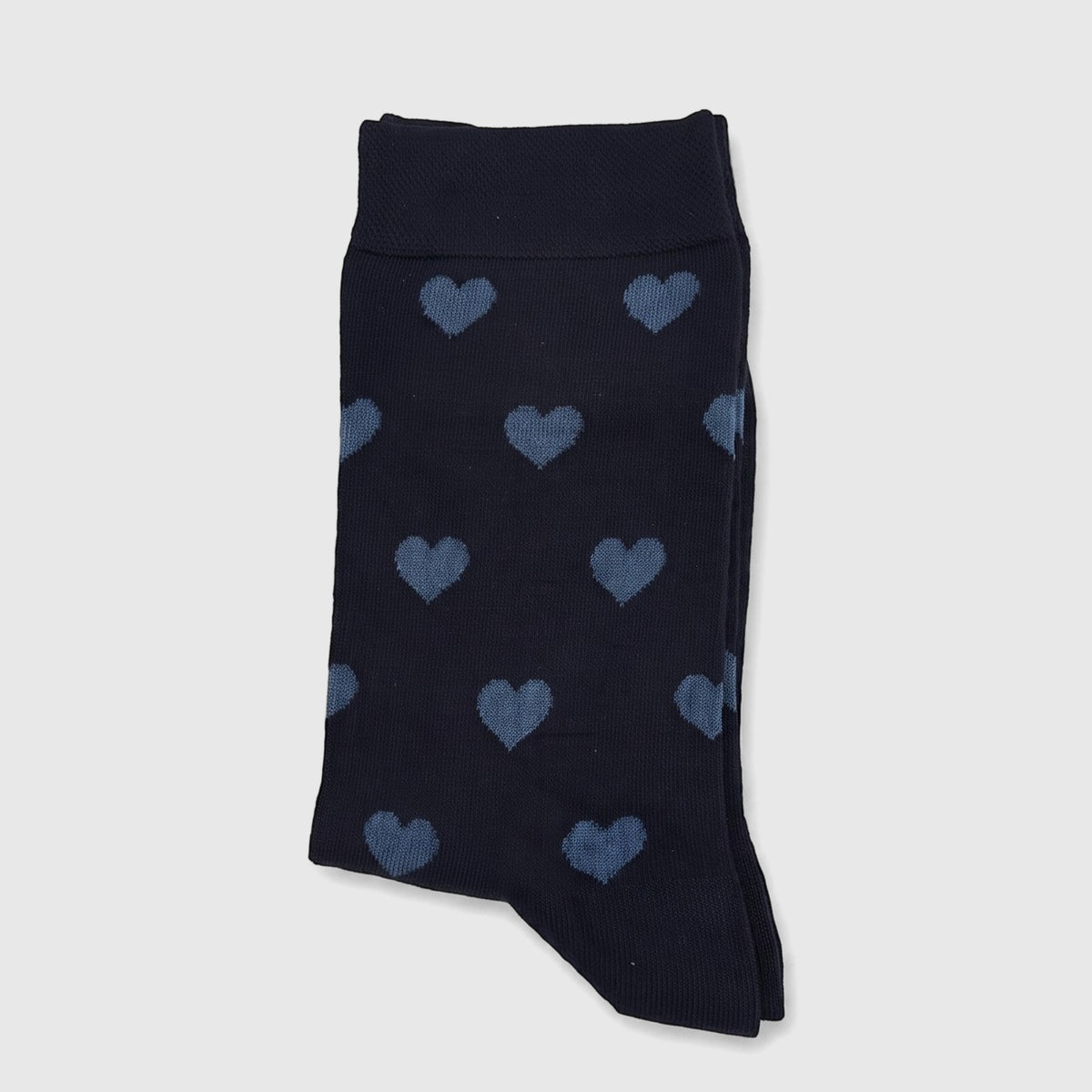 Navy blue ladies bamboo socks with a light blue heart pattern, neatly folded and presented on a plain surface.