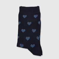 Navy blue ladies bamboo socks with a light blue heart pattern, neatly folded and presented on a plain surface.