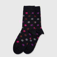 Pair of Ladies Pure Cotton Socks in black with vibrant pink, purple, and gray polka dots, presented in a flat lay.