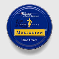 Meltonian Shoe Cream Black 50ML in a blue circular tub with a yellow label, viewed from above, designed for shoe care.