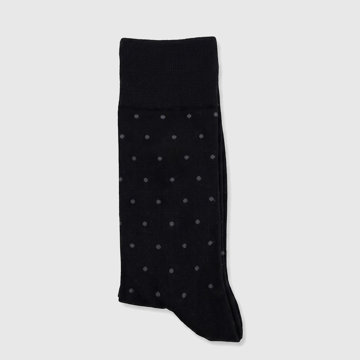 Men's black Micro Modal socks with white polka dots, folded and displayed in packaging, size UK6 to UK11.