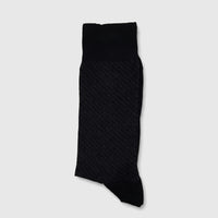 Single men's black micro modal sock with subtle diagonal stripes, laid flat on a surface.