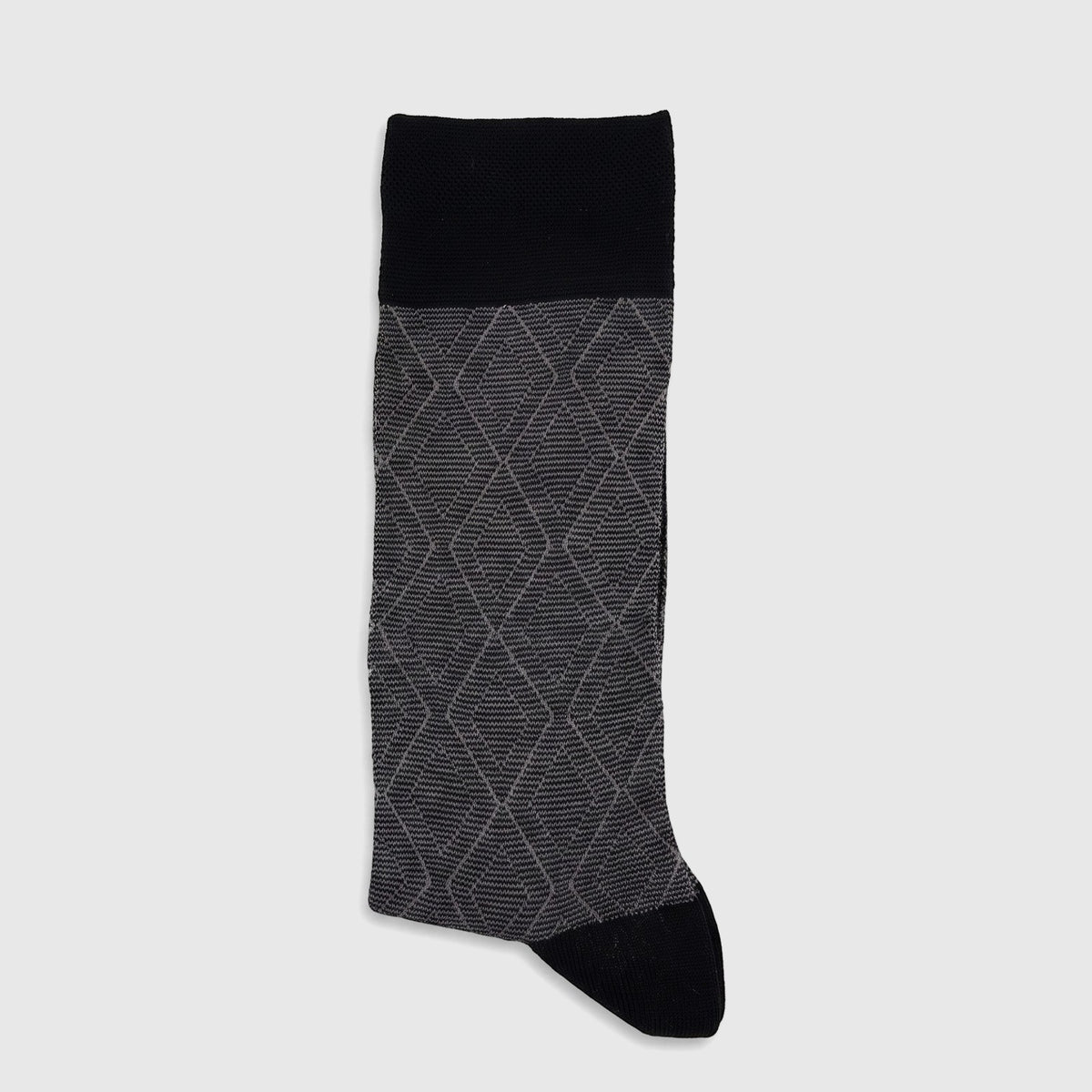 A single men's mercerised bamboo sock, black at the cuff and toe, with a grey diamond argyle pattern on the main body, laid