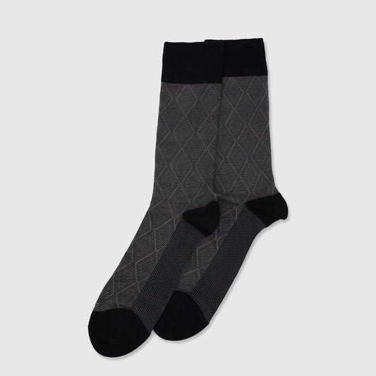 A single men's mercerised bamboo sock, black at the cuff and toe, with a grey diamond argyle pattern on the main body, laid