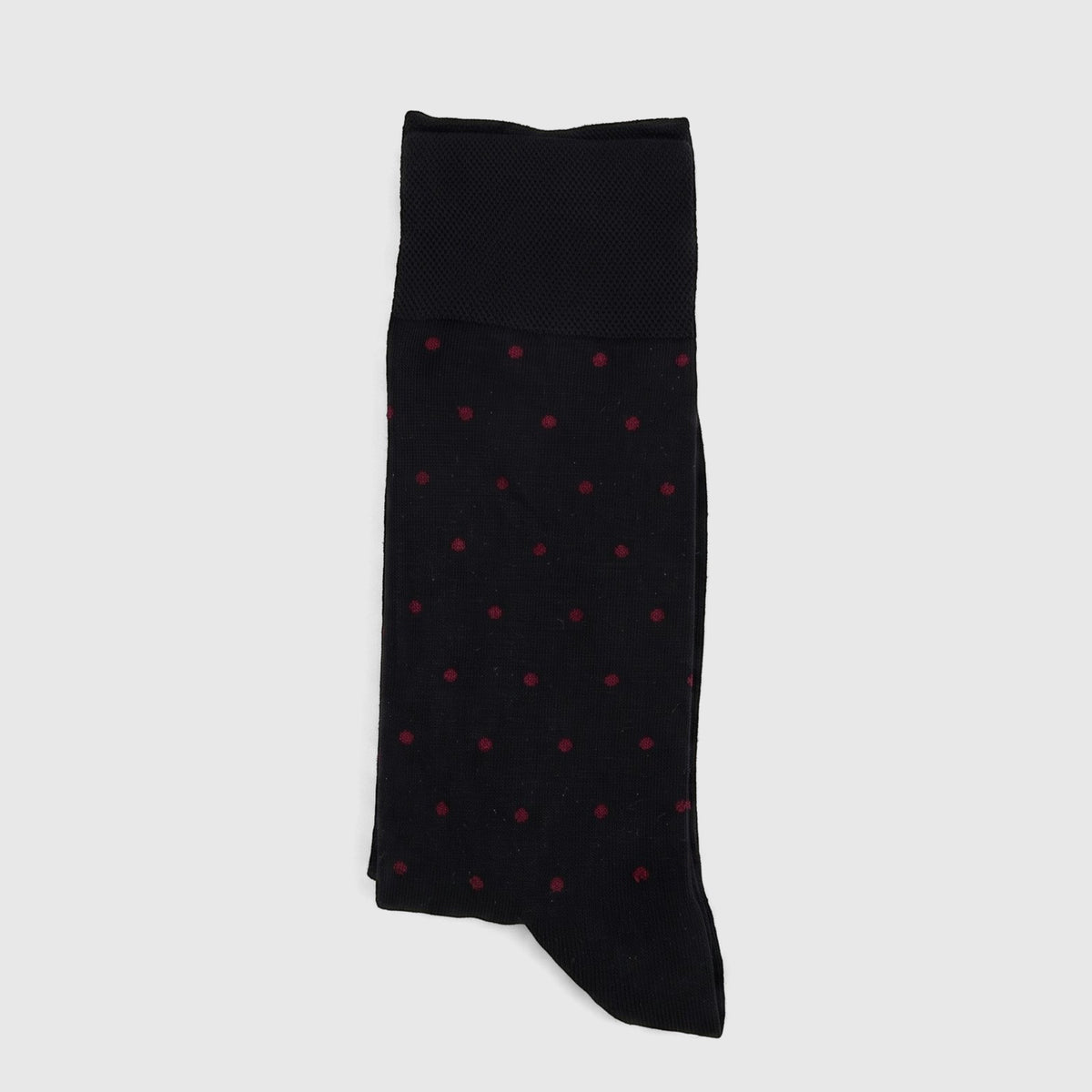 A single black Men's Micro Modal Sock with red polka dots, folded and laid flat, from the Black Bordeaux collection.