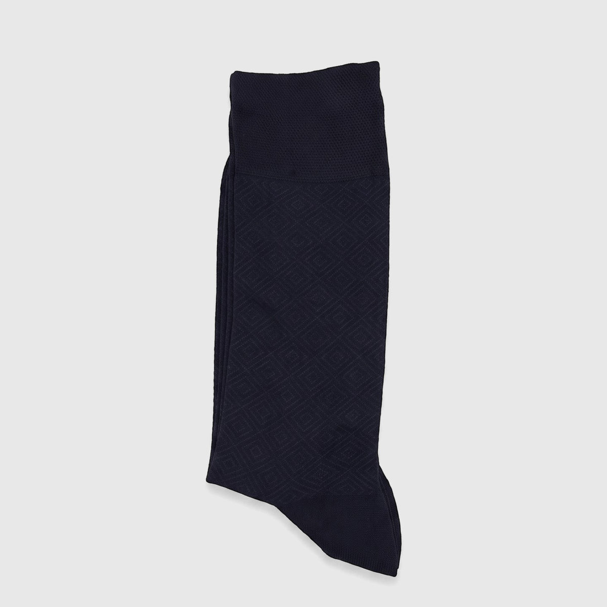 A single navy men's micro modal sock, featuring a subtle diamond pattern, lies folded flat on a white surface.