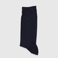 A single navy men's micro modal sock, featuring a subtle diamond pattern, lies folded flat on a white surface.