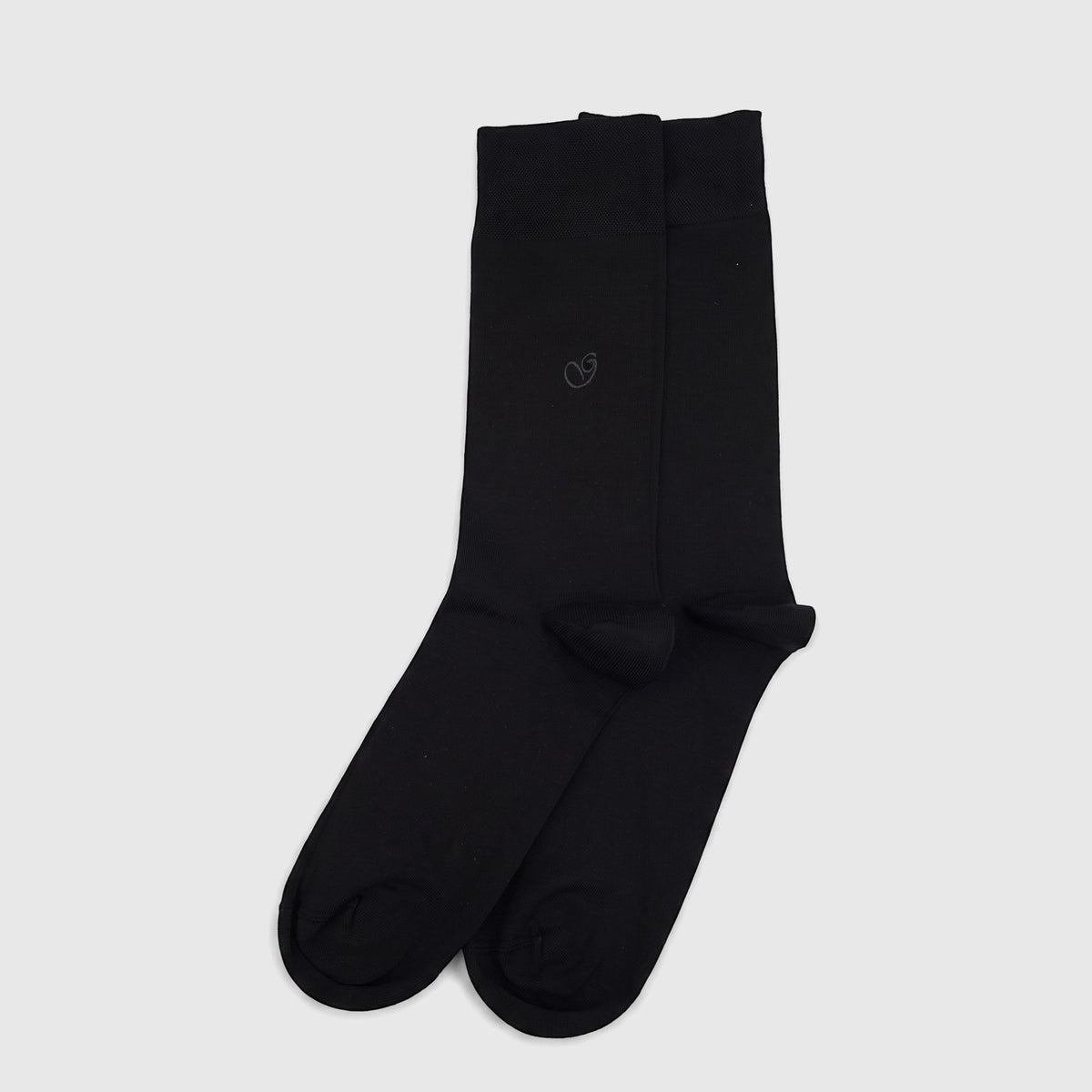 A pair of men's black pure cotton socks, size UK6 to UK11, lying flat on a white surface, showcasing their smooth texture