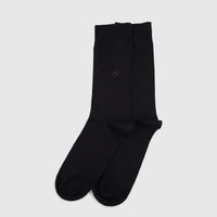 A pair of men's black pure cotton socks, size UK6 to UK11, lying flat on a white surface, showcasing their smooth texture
