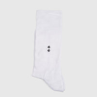 Folded men's white bamboo sock with a ribbed cuff and two dark diamond patterns, shown in a flat-lay view.