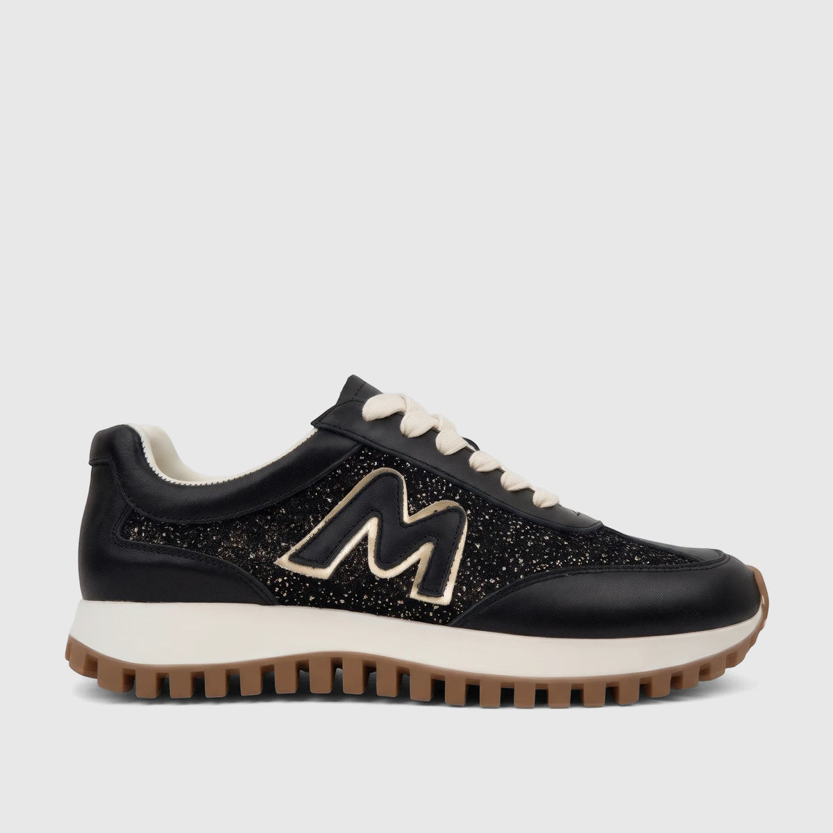 Morbido black leather sneaker with glitter panels, cream laces, and a prominent gold 'M' logo, shown in a side view.