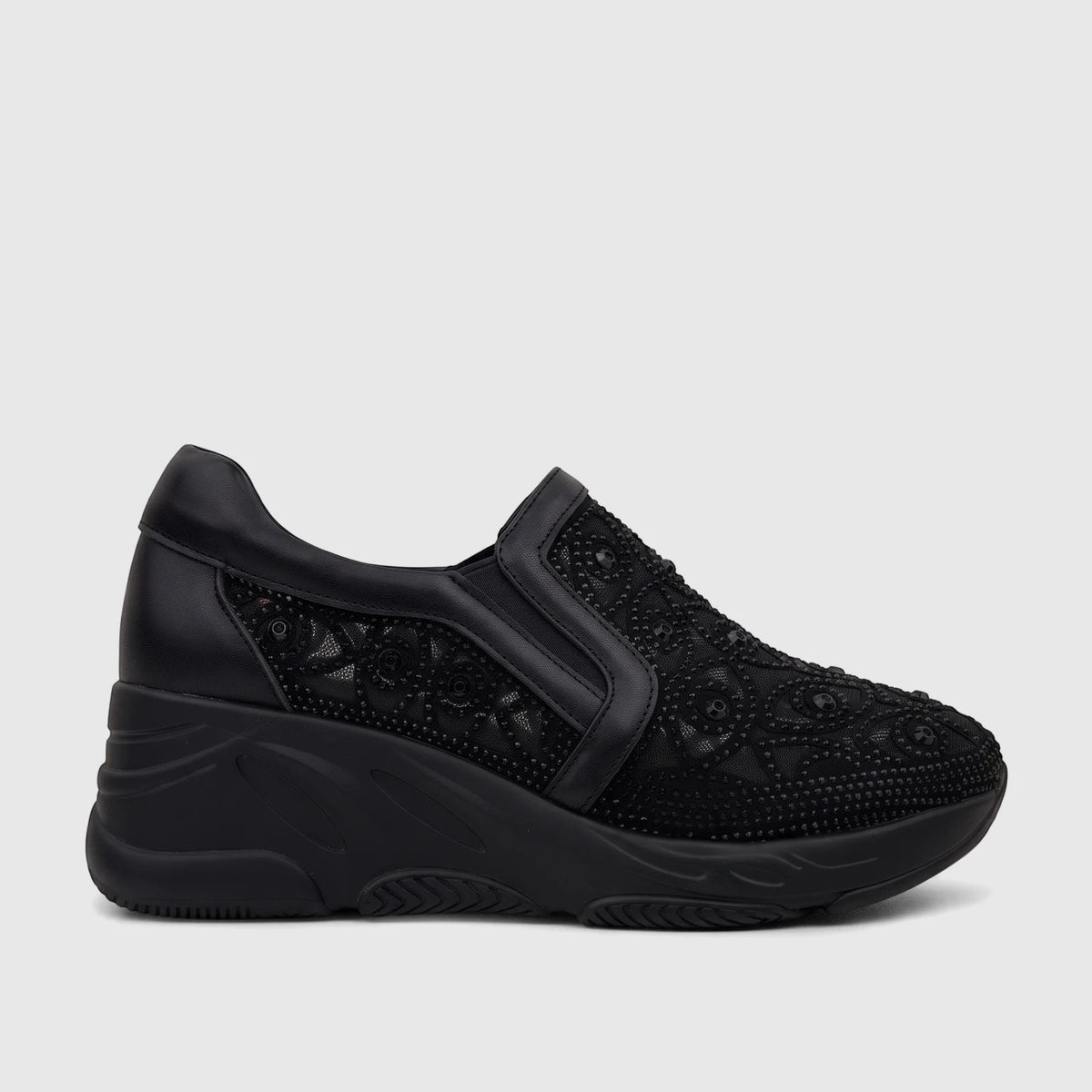 Morbido Ladies black leather slip-on sneaker with mesh and embellishments, shown from a side view.